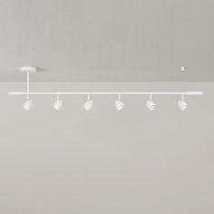 an overhead light fixture with five bulbs on the ceiling and four lights hanging from the ceiling