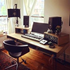 there are many electronic equipment on the desk in this room, including keyboards and monitors