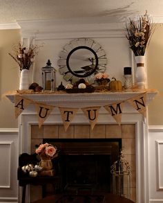 an autumn mantle decorated with flowers and pumpkins