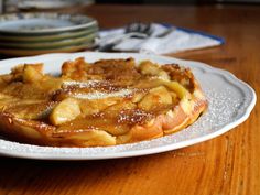 a white plate topped with food on top of a wooden table