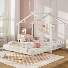 a child's bedroom with a white bed and pink walls, wooden flooring