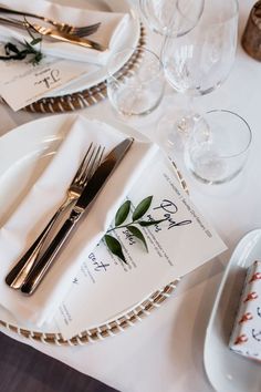 the table is set with silverware, napkins and place settings for an elegant dinner