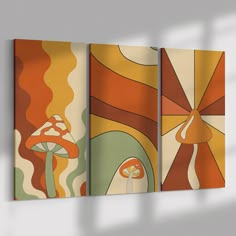 three abstract paintings hanging on the wall