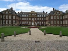 a large building with lots of windows and grass