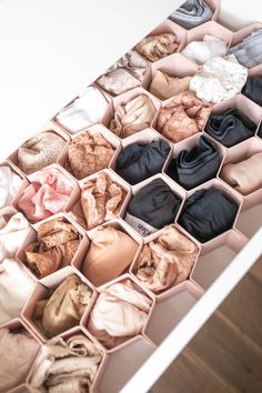 an open drawer filled with different types of clothes