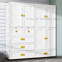 a white and yellow armoire in a room next to a wall with the words ray of sunshine store on it