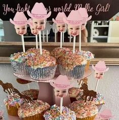 there are cupcakes that have been placed on top of each other with pictures of babies in hats