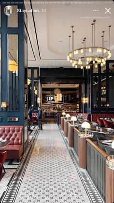 the interior of a restaurant with red velvet booths and chandeliers hanging from the ceiling