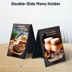 two menu boards sitting on top of a wooden table