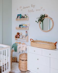 a baby's room with white furniture and shelves