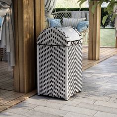 a white and black box sitting on top of a patio