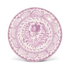 a pink and white plate with an ornate design on it's rim, against a white background