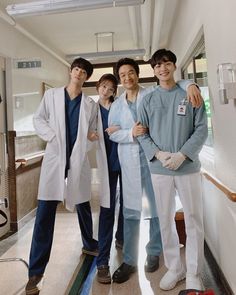 four people in scrubs are posing for a photo