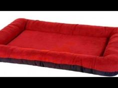 a large red dog bed with black trim