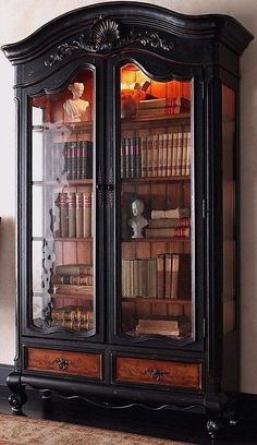 an old fashioned bookcase with many books in it's glass doors and shelves