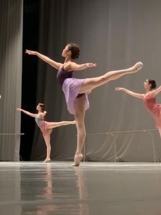 three ballerinas are practicing their moves on the dance floor