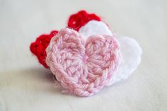 two crocheted hearts sitting on top of each other