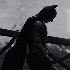 the dark knight is walking up some stairs