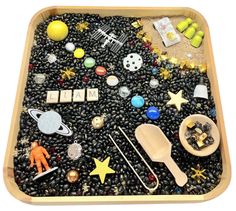 a wooden tray filled with lots of different types of toys and items on top of it