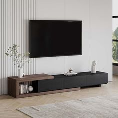 a living room with a large flat screen tv mounted on the wall and a vase in front of it