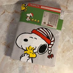 a towel with a snoopy character on it sitting on top of a marble counter