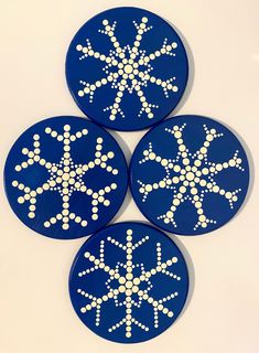 three blue snowflakes with white dots on them