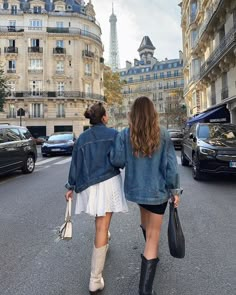 two women walking down the street in paris