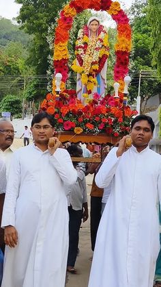 three men standing in front of a shrine