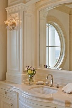 a bathroom with two sinks and a large mirror in it's center area,