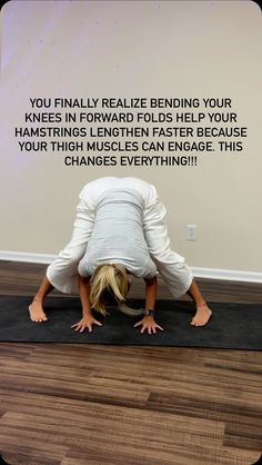 a woman in white shirt doing yoga on black mat with words above her saying, you finally reliee bending your knees in forward folds help