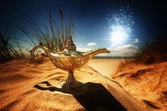 a golden teapot sitting on top of a sandy beach under a blue sky with clouds