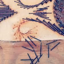 several pieces of wood are arranged in the shape of hearts and arrows on a table