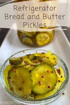 a glass bowl filled with pickles on top of a table