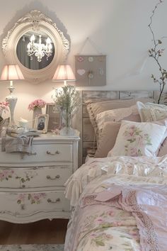 a bedroom with a dresser, mirror and flowers on the nightstands in front of it