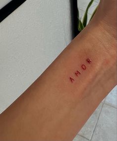 a woman's arm with the word roma written on it, in cursive font