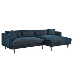 a blue sectional couch with wooden legs