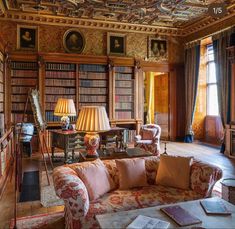 a living room filled with furniture and bookshelves covered in lots of bookcases