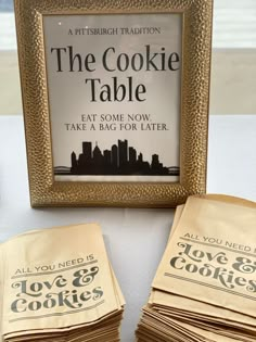 the cookie table is set up with cookies in front of it and an advertisement for love & cookies