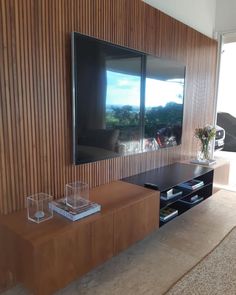 a living room with a large flat screen tv mounted to the side of a wall