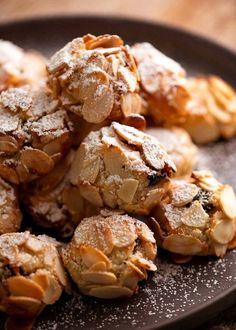 a plate full of cookies covered in powdered sugar