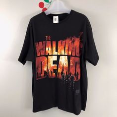 the walking dead t - shirt hanging on a wall