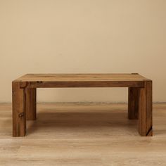 a wooden bench sitting on top of a hard wood floor