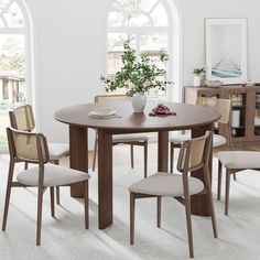 a dining room table with four chairs around it