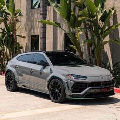 a silver sports car parked in front of a building