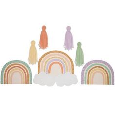 an assortment of rainbows and clouds with tassels on the top, in pastel colors