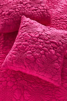 two pink pillows on top of each other