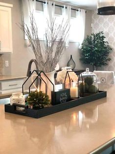 a kitchen counter with candles and decorations on it