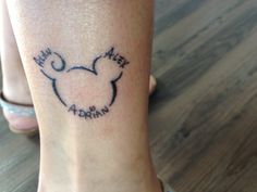 a woman's foot with a mickey mouse tattoo on her left ankle and the word my heart is arran written in black ink