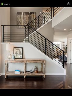 a room with a table and stairs in it