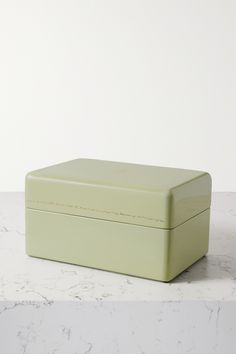 a green box sitting on top of a white counter